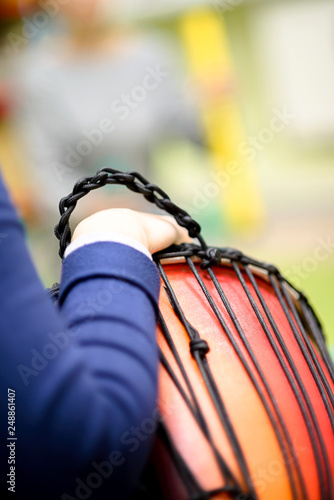 Man's Hand with Musical Instrument African Djembe Meinl. Shallow depth of field photo