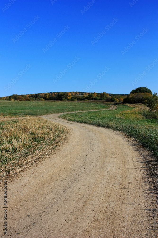 Dirt country road in the field Dirt country road in the field