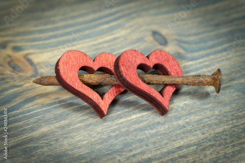 Wooden hearts with rusted nail