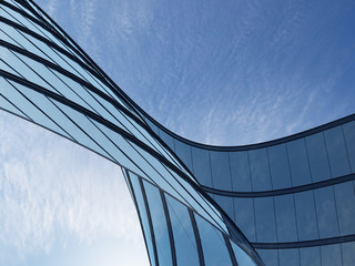 3D stimulate of high rise curve glass building and dark steel window system on blue clear sky background,Business concept of future architecture,lookup to the angle of the corner building.