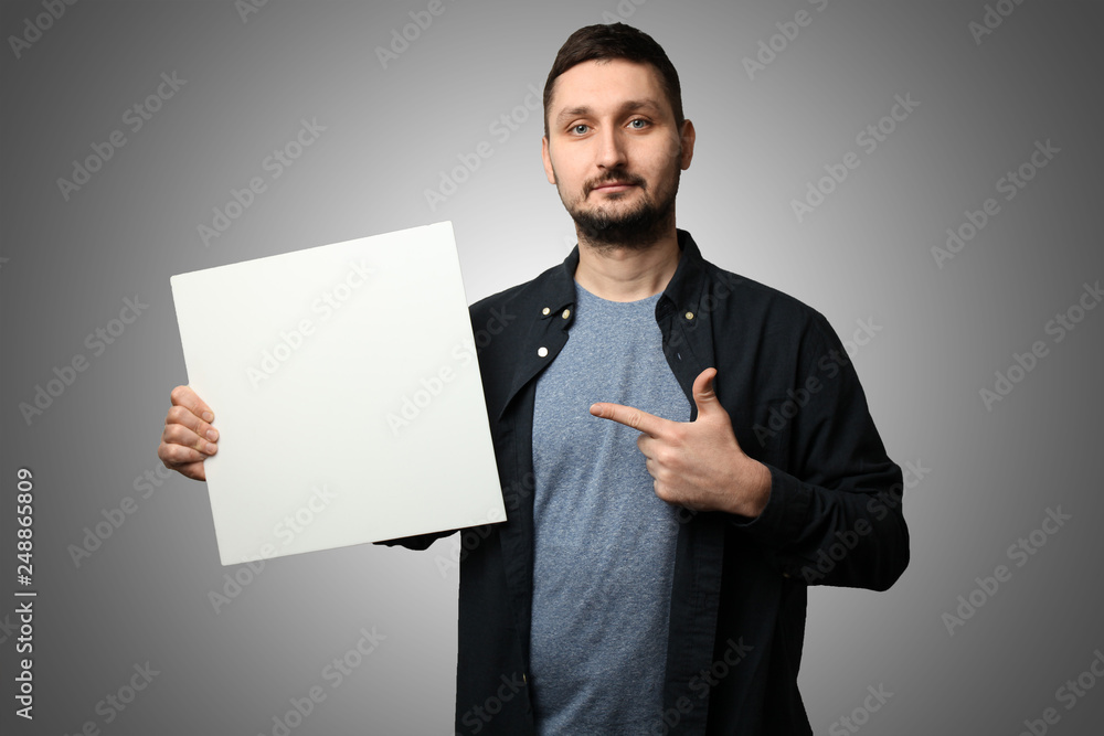 White man with beard and in cap holds banner (poster), empty space for text. White man with beard and in cap holds banner (poster), empty space for text.