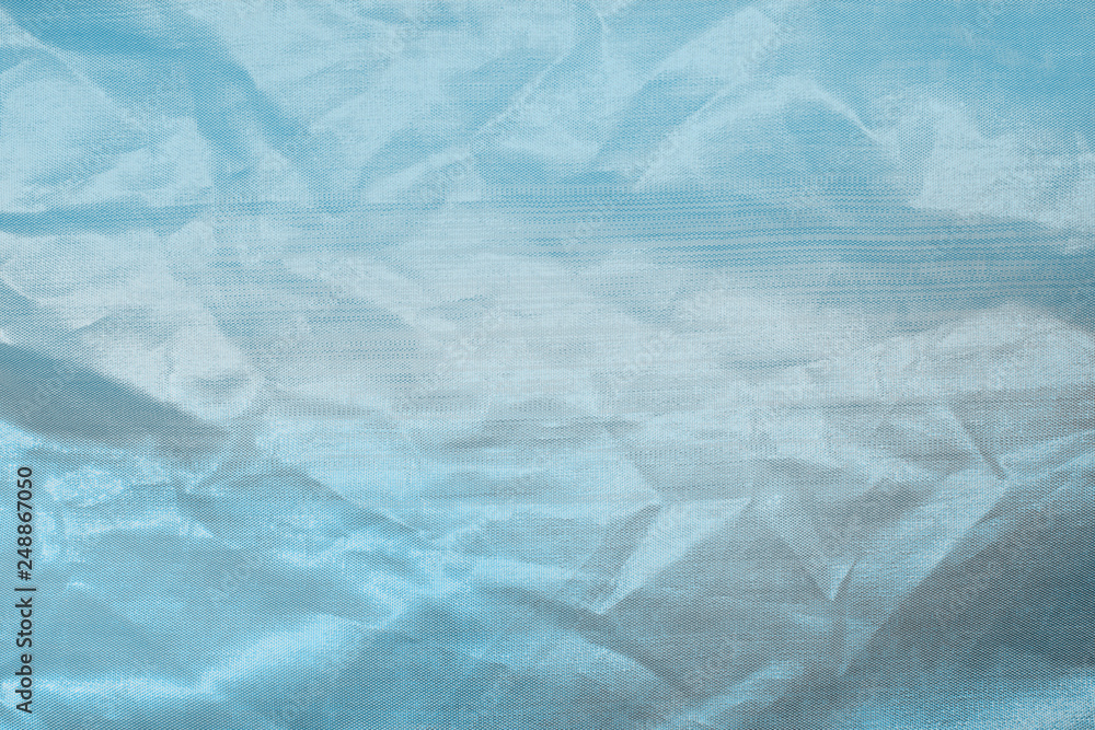 Fototapeta premium Ocean blue textile background. Silk cloth texture. Fabric pattern.