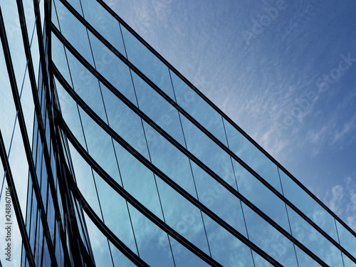 3D stimulate of high rise curve glass building and dark steel window system on blue clear sky background,Business concept of future architecture,lookup to the angle of the corner building.