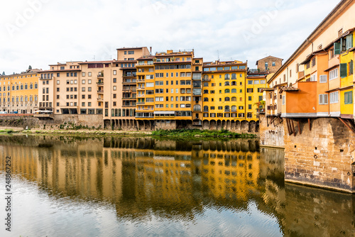 Florence  Italy Firenze orange yellow colorful building on Ponte Vecchio by Arno river during summer morning in Tuscany with nobody vibrant