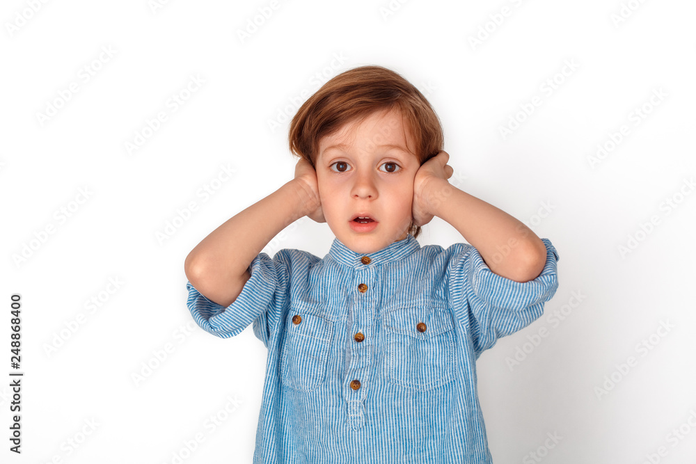 Boy studio standing isolated on grey covering ears confused Boy studio standing isolated on grey covering ears confused