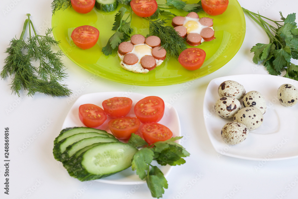 Breakfast of sausages, quail eggs, herbs and vegetables. Breakfast of sausages, quail eggs, herbs and vegetables.