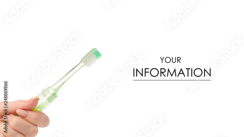 Travel green toothbrush in hand pattern on white background isolation