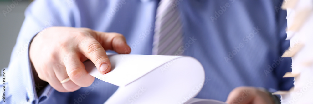 Clerk arm bend over pages in pile of documents closeup Clerk arm bend over pages in pile of documents closeup