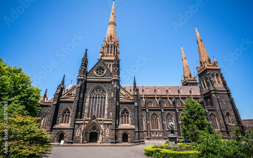 Side view of St Patrick's Cathedral and spire a Roman Catholic Cathedral church in Melbourne Vic Australia