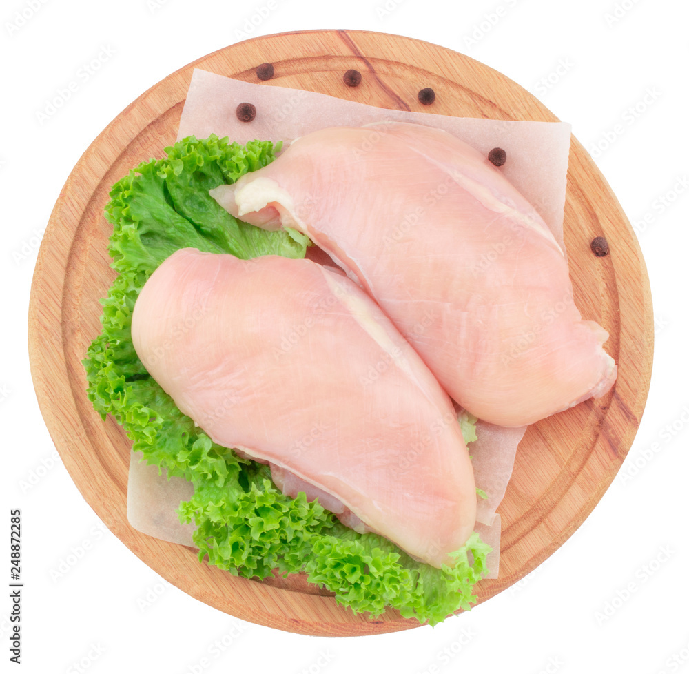 Raw chicken breast fillets on wooden cutting board isolated on white background