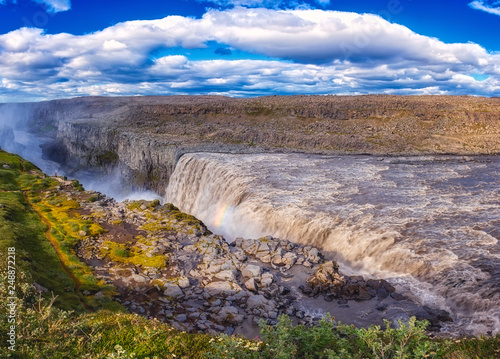 Amazing nature landscape, stunning Dettifoss waterfall with rocky canyon and blue cloudy sky Iceland. Scenic panoramic aerial view, outdoor travel background. Vatnajökull National park