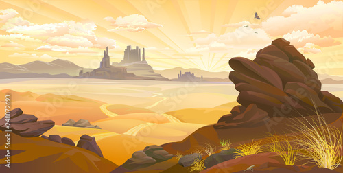 Sunrise over the canyons with dry grass and big boulders