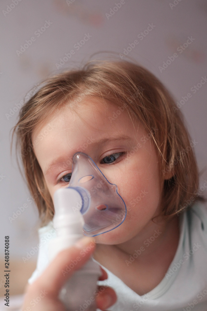Infant with asthma inhalator.