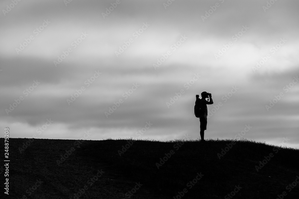 silhouette of man on top of mountain