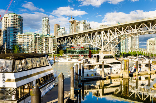 Boats Tied up to Jetty under Granville Bridge in Vancouver, Canada, on a Clear Summer Day
