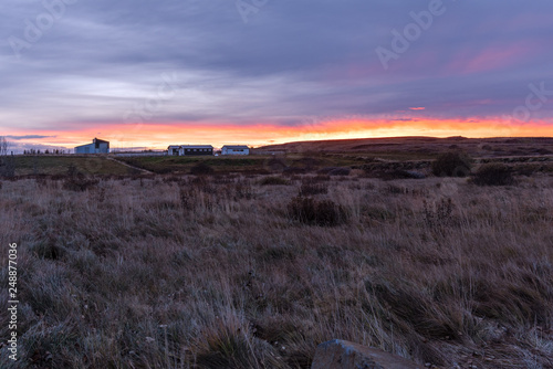 Farmhouse and Barns in the Countryside of Iceland at Sunset