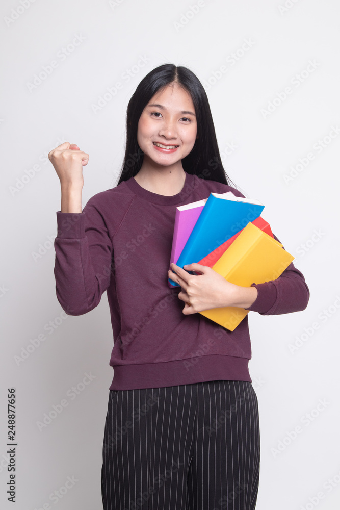 Young Asian woman studying with may books. Young Asian woman studying with may books.