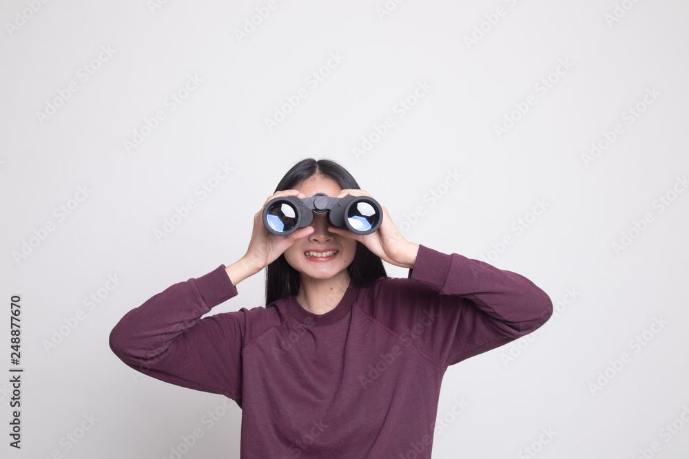 Young Asian woman with binoculars. Young Asian woman with binoculars.