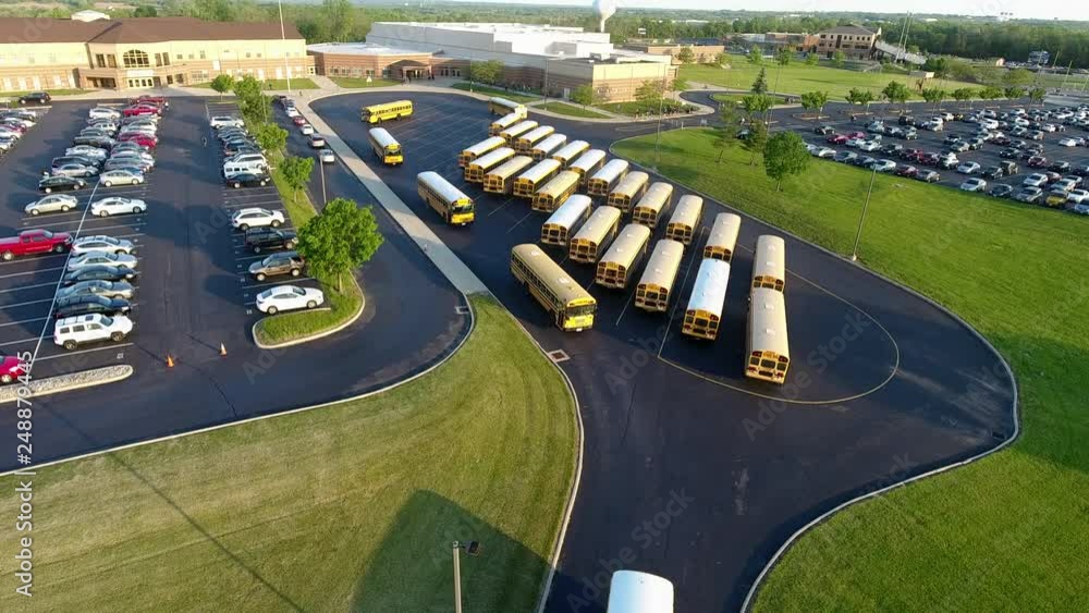 school buses leaving parking lot after unloading students Stock Video ...