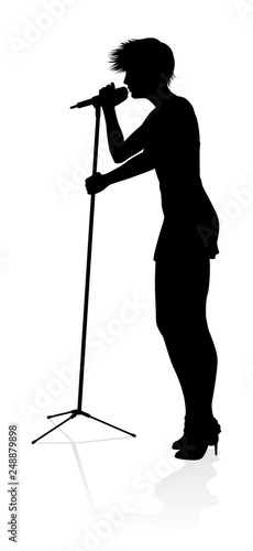 A woman singer pop, country music, rock star or even hiphop rapper artist vocalist singing in silhouette