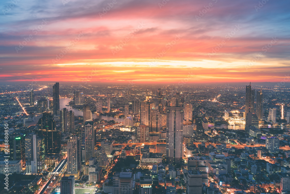 Fototapeta premium Bangkok city river curved skyline with sunset light.