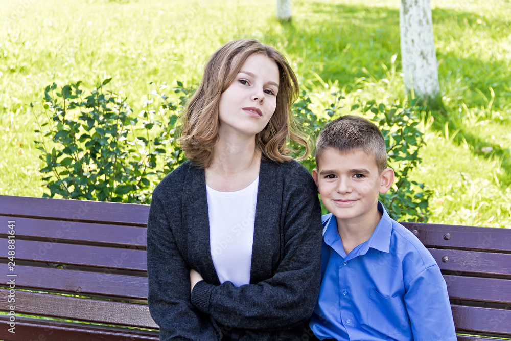 Brother and sister are sitting on bench Brother and sister are sitting on bench