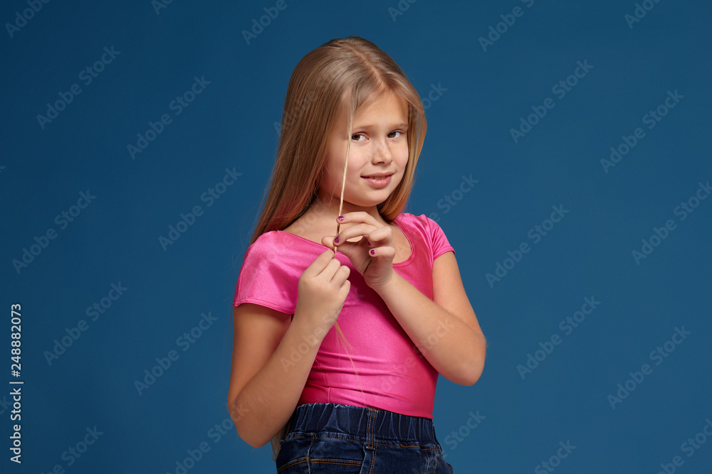 Portrait of adorable emotional little girl on blue background Portrait of adorable emotional little girl on blue background