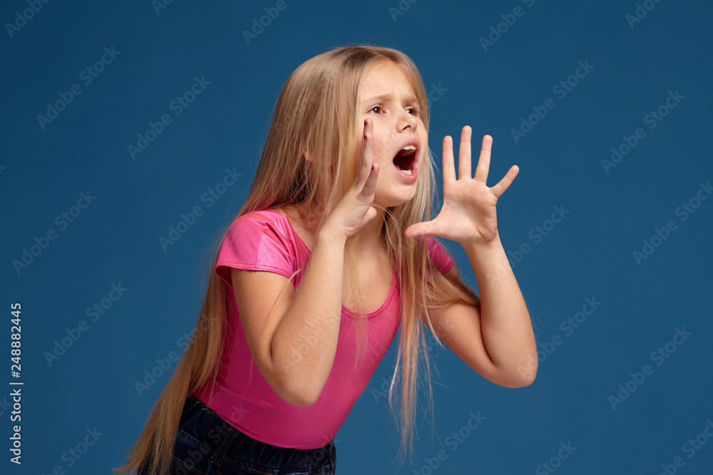 Portrait of emotional little girl on blue background Portrait of emotional little girl on blue background