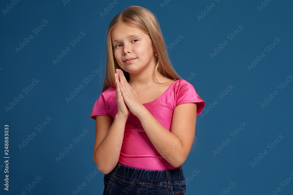 Portrait of adorable emotional little girl on blue background Portrait of adorable emotional little girl on blue background