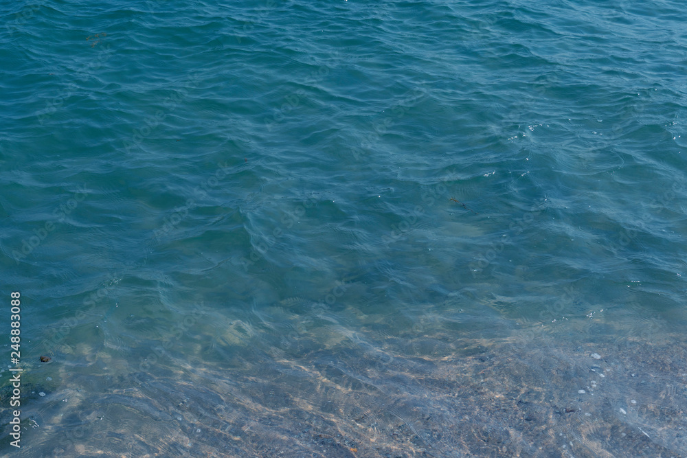 Obraz premium Clear sea water overlooking the sandy beach on the south side.