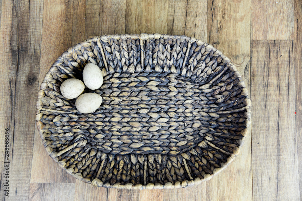 Basket with paper mache' Eggs on Wood Background Basket with paper mache' Eggs on Wood Background