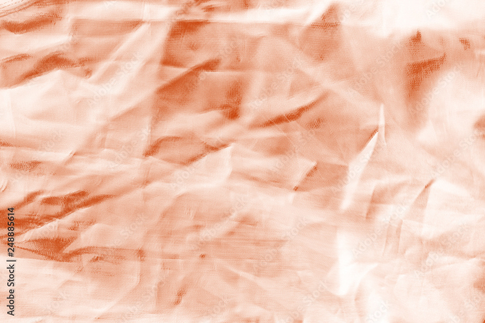 Fototapeta premium Elegant orange textile background. Silk cloth texture. Fabric pattern.