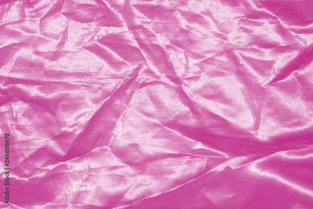 Fototapeta premium Elegant pink textile background. Silk cloth texture. Fabric pattern.