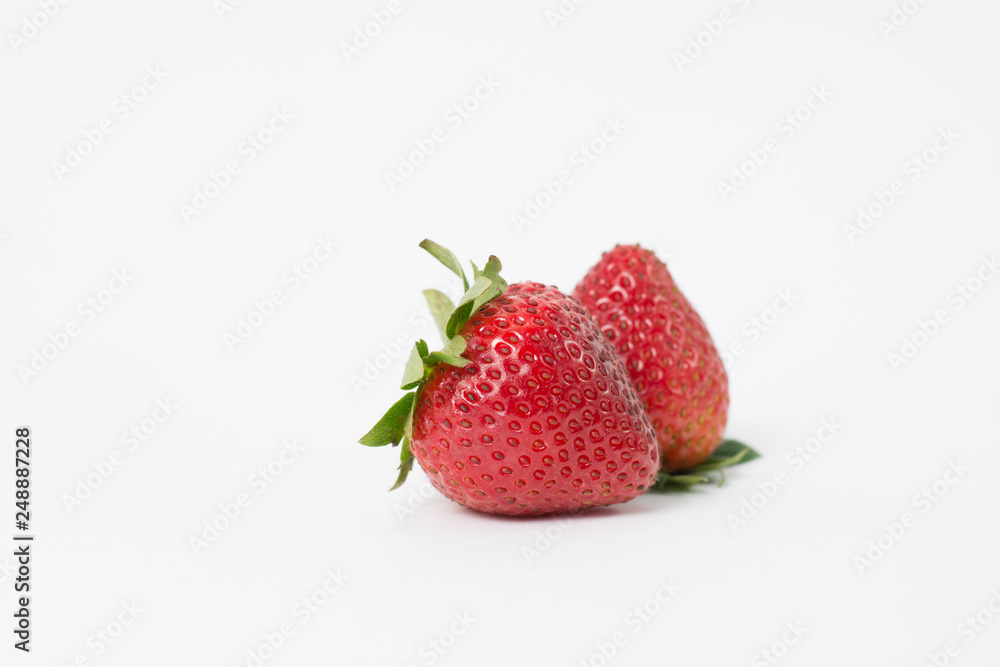 Two red strawberries On the white background Two red strawberries On the white background