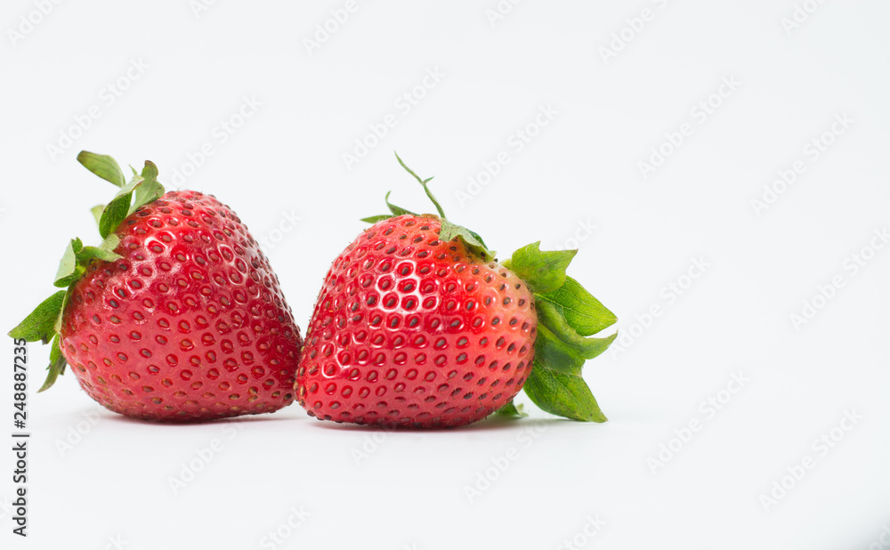 Two red strawberries On the white background Two red strawberries On the white background