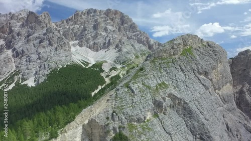 Stunning aerial video near Cortina D‚ÄôAmpezzo of Dolomites and their special rocks, Unesco Heritage, at Cristallo mountain area in Summer season. photo