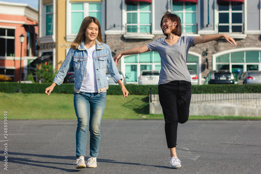 Group of young Asian women walking in an outdoor market in urban city, cheerful beautiful female feeling happy travel together. Lifestyle women travel holiday together concept.