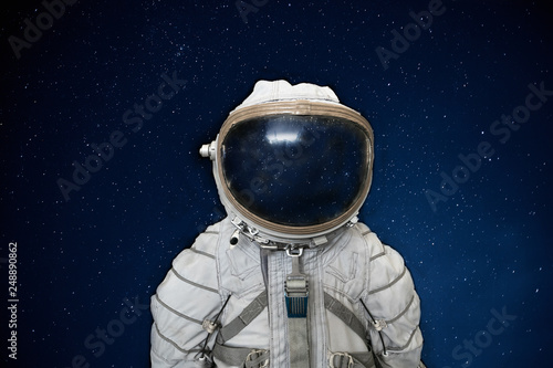 Soviet cosmonaut or astronaut or spaceman suit and helmet on black space with stars background