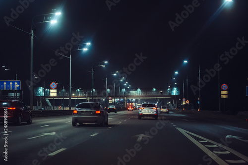Urban city traffic cars in night illuminated asphalt city road, abstract cityscape transportation concept © DedMityay