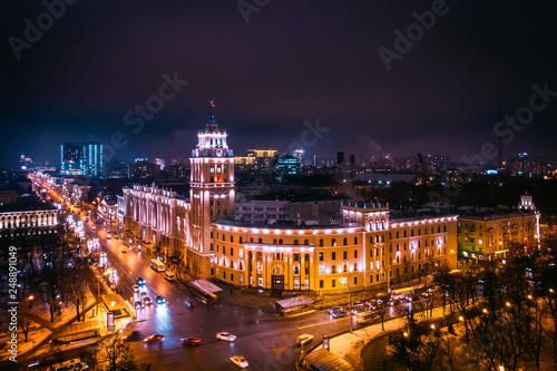 Arial view of famous Voronezh building with tower in night, symbol of Voronezh and evening cityscape with rads, parks and traffic, drone shot