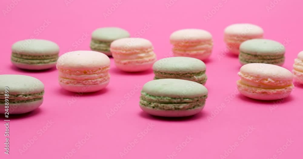 Multiple delicious sweet macaroons dessert on pink background Multiple delicious sweet macaroons dessert on pink background