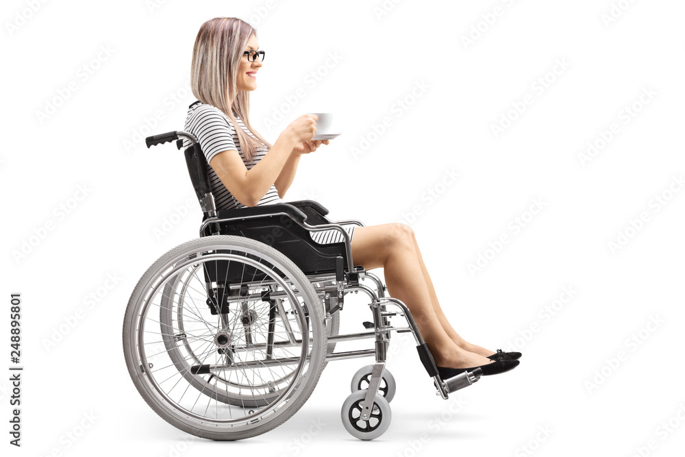 Young woman in a wheelchair holding a cup of coffee Young woman in a wheelchair holding a cup of coffee