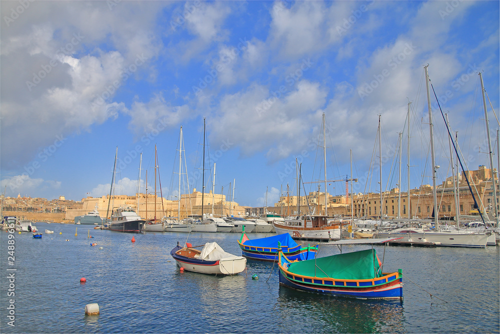 Traditional Maltese boats moored in the harbor of the island.