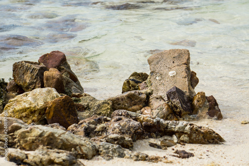 the rock on sea background. © Rattaphol