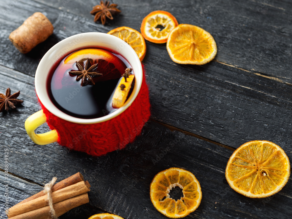 Mug of warm mulled wine from red wine with spices and citrus Mug of warm mulled wine from red wine with spices and citrus