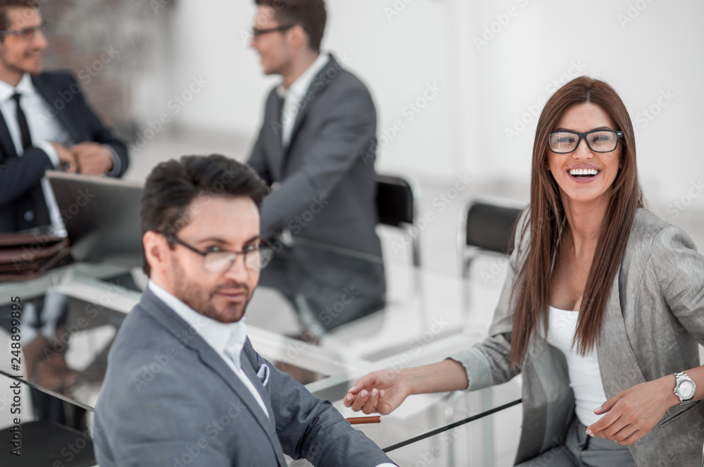businessman and business woman sitting at office Desk businessman and business woman sitting at office Desk