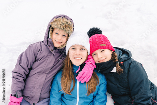 Group of three young girl friends outdoors in winter
