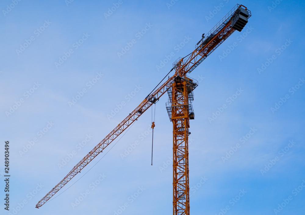 tower crane on blue sky background, isolated