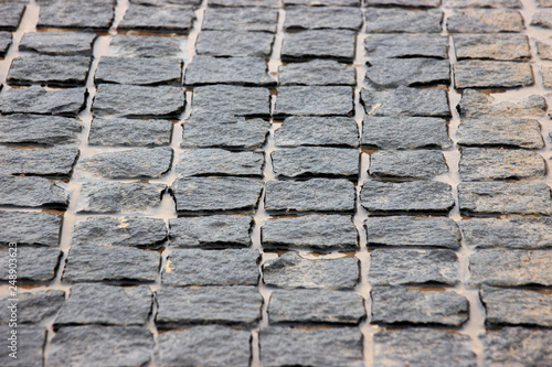 the track is made of cobblestones, strong material for construction. reliable blind spot. puddles between the bricks. background for creativity