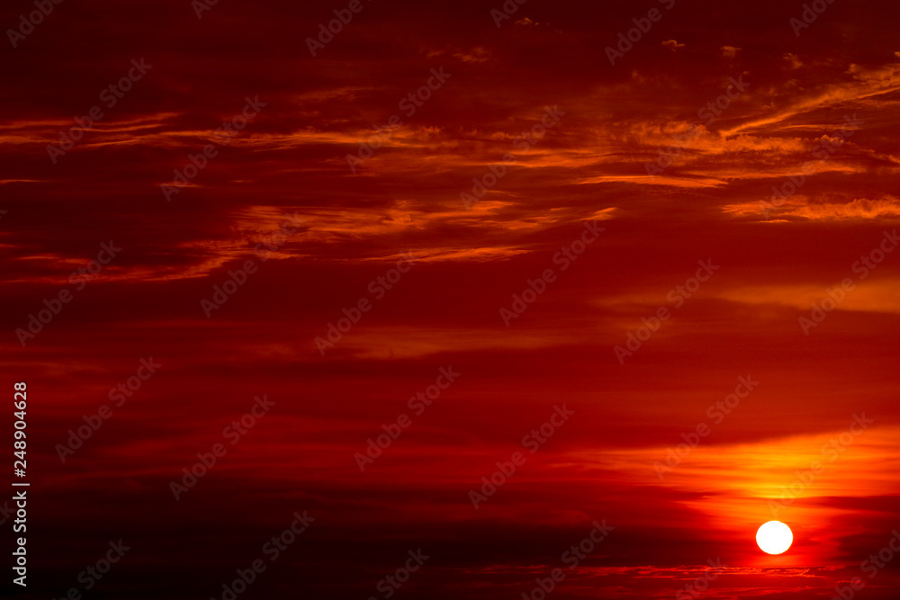 last light sunset on the red cloud sky ray around sun